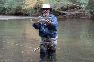 A veteran catching a fish having a lot of fun.