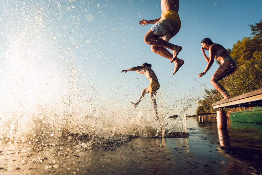 a swimming spot with people jumping in